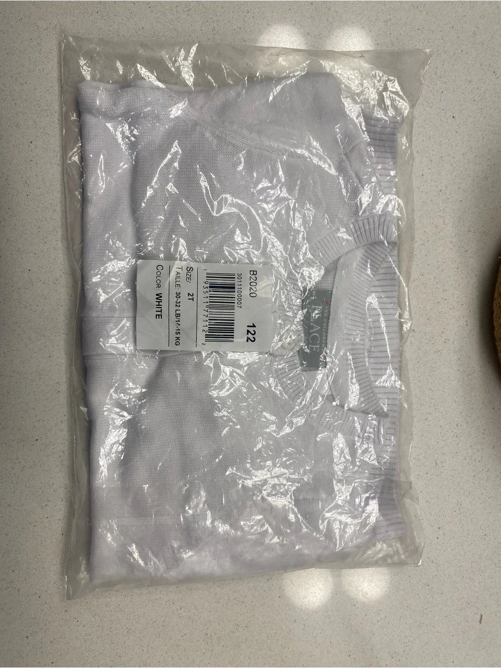 Men's white folded shirt in packaging